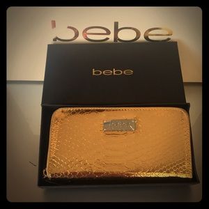 Bebe Ona Wallet snake print in gold.